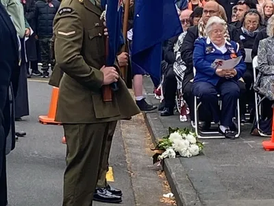 People sitting on steps wearing traditional Indian clothing.
